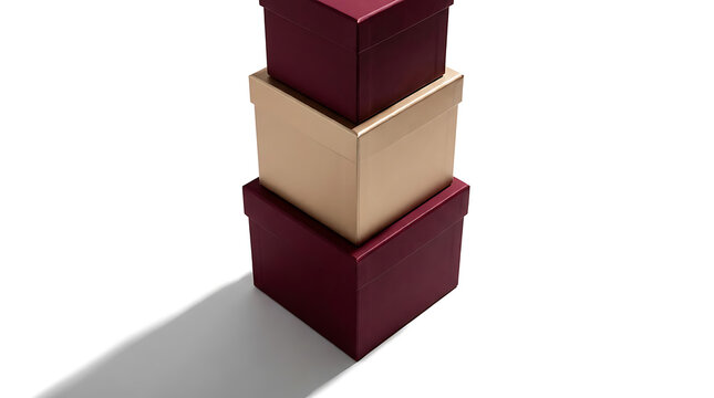 Stack of three plain gift boxes in burgundy and gold colors isolated on white background with shadow