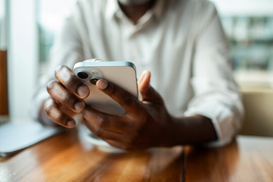 Person using smartphone at cafe table