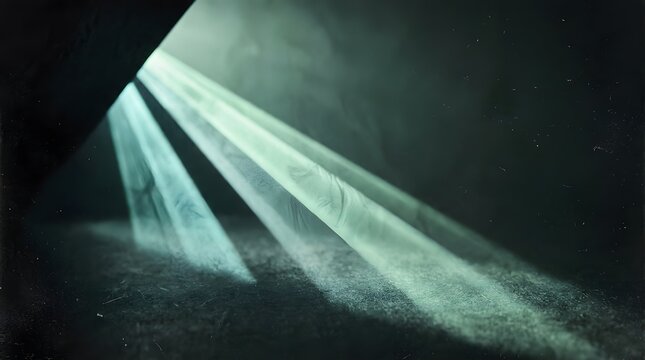 Dramatic light rays shining through a dark void onto a textured ground surface with beam of light dark environment textured floor