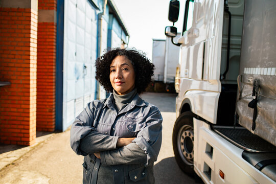 Confident female truck driver at logistics depot