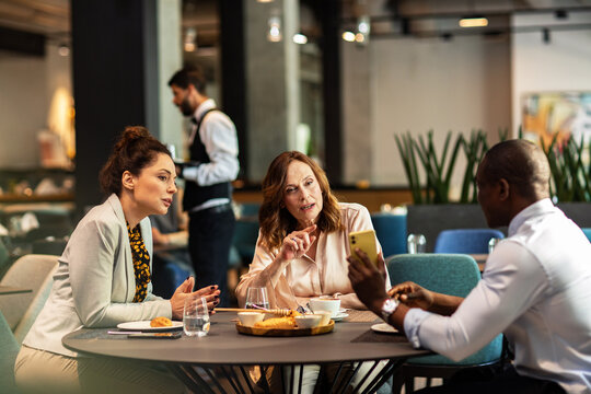 Business colleagues meeting over coffee in a cafe