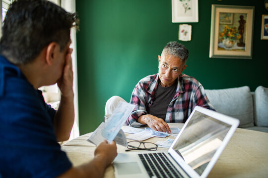 Two adults reviewing household bills at home