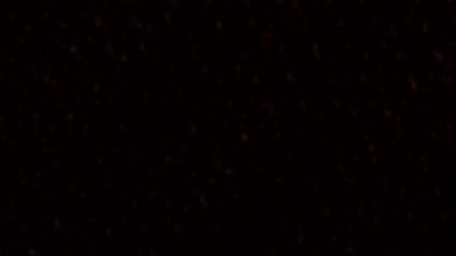 Subtle red dot overlay on a solid black background for seamless looping motion