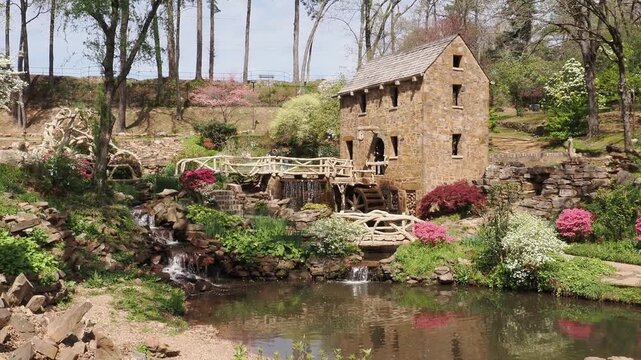 Stone mill with waterwheel and garden.