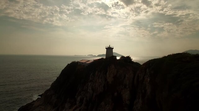 Aerial View of Lighthouse on Coastal Cliff at Sunset, Fujian Coast, East China Sea