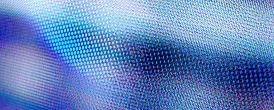 Close-up of a glowing digital screen. Blue hues pulse softly across the display. Pixelated patterns shift subtly with light. Ideal for tech, media, or futuristic themes