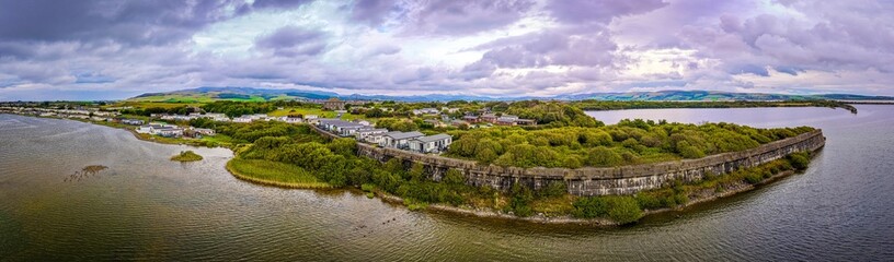 Obraz premium Haverigg Village Waterfront with Church and Lakeland Fells in Cumbria England