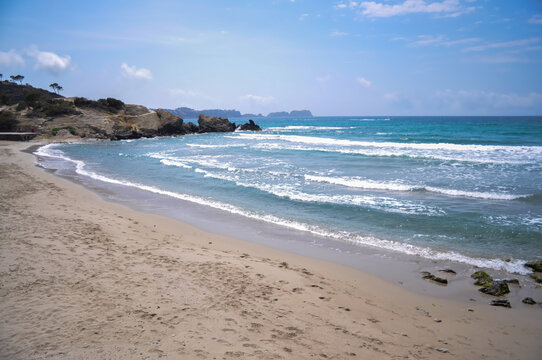 Mallorca Spain: Serene Beach Scene with Waves and Sand