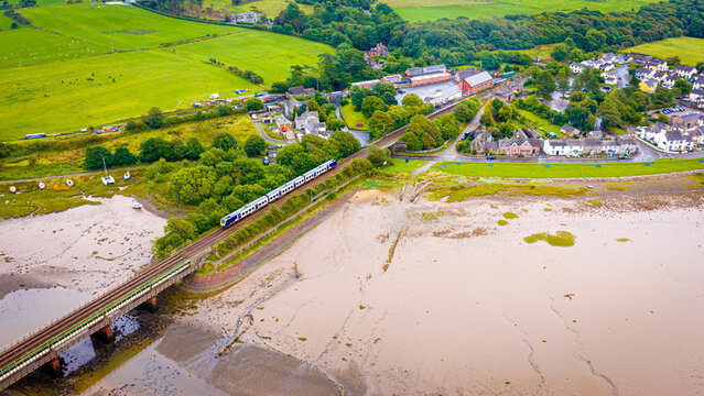 Passenger Train Passing Ravenglass at Low Tide on the Cumbrian Coast England
