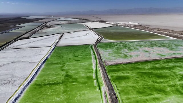aerial view of green salt lake evaporation ponds and crystallization pools