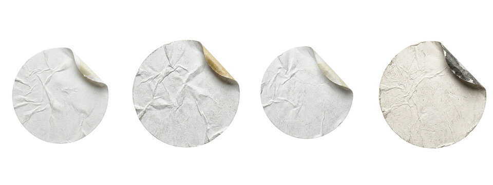 Set of four round white wrinkled paper stickers with curled edges on transparent background