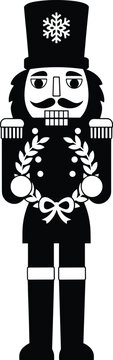 Black and white silhouette of a nutcracker soldier holding a christmas wreath, isolated on a white background, for festive holiday