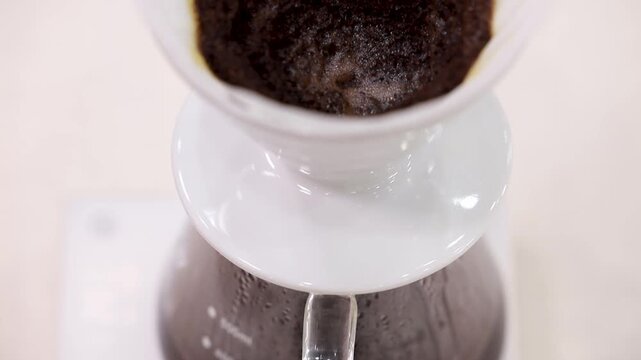 Coffee grounds blooming in a white dripper
