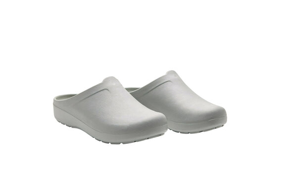 Pair of white slip-on clogs with textured soles on white solated on transparent background
