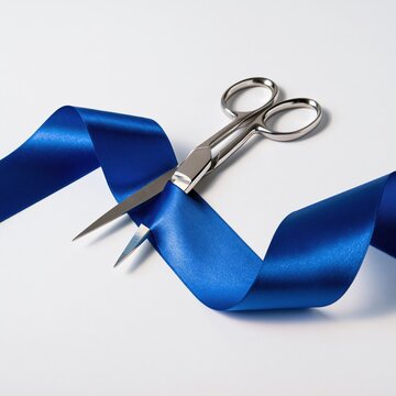 Scissors cutting blue ribbon on white background