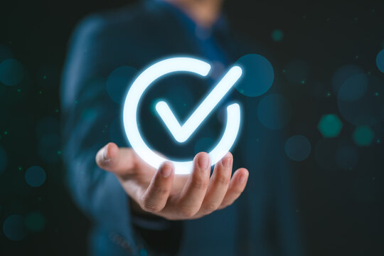 Service guarantee, Validation concept for business process automation, quality assurance management, certification, digital transformation. Businessman show checked icon on hand. Quality control.