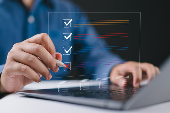 Document management system DMS. Assessment form, questionnaire, checklist and clipboard task management. Businessman working on laptop computer productivity checklist and filling survey form online.