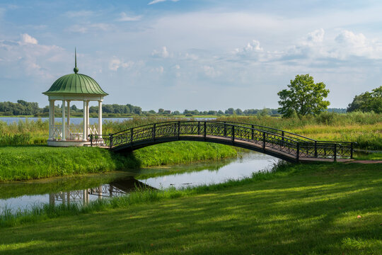A gazebo with a bridge on the bank of the Volkhov River in the Novgorod Museum of Folk Wooden Architecture Vitoslavlitsy on a sunny summer day, Veliky Novgorod, Russia
