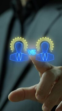 Businessman finger touching glowing versus text between two executive avatars with gears vertical shot. Corporate competition rivalry, business performance comparison, and benchmark idea concept.