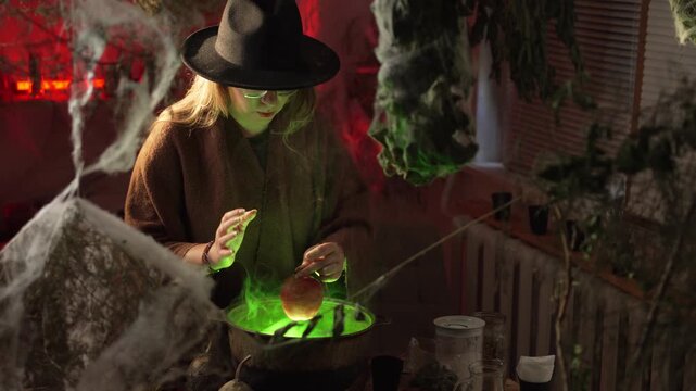 A realistic witch brewing a potion. She waves her hand over the cauldron while chanting a spell, holding a red apple in her other hand.. Magic and a mystical atmosphere.