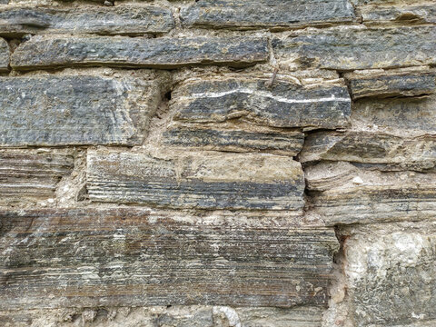 Natural flagstone masonry. Stone wall, brown background.