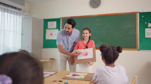 Caucasian girl student presenting drawing artwork to classmates in classroom. 