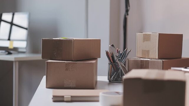 Close up with Start up small business, SME female owner using laptop checking order online to prepare to pack a box of goods for sale to customers, sme business idea.