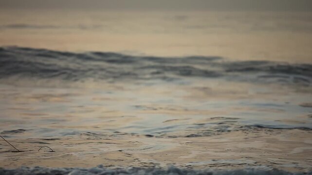 Silhouette of Fisherman Throwing Net into Ocean Waves at Sunset