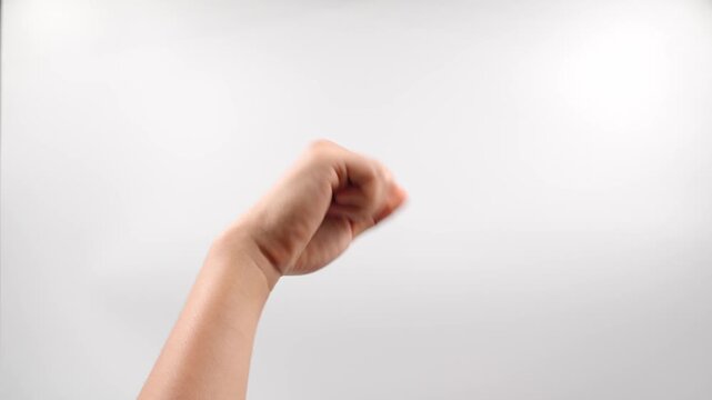 Man hand showing symbol , YES sign in American Sign Language (ASL)  Sign Language (ASL), you make a fist and bob it up and down at the wrist to mimic a head nodding.