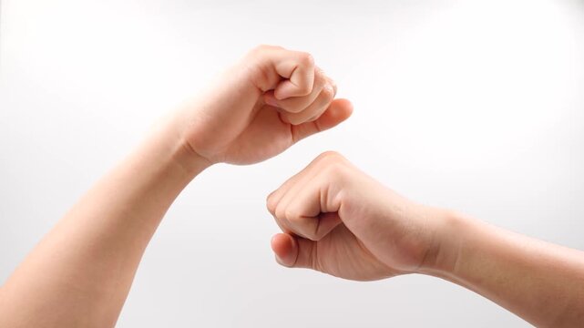 The American Sign Language  sign for "rock" as in a stone is made by forming both hands into fists and tapping the dominant fist twice on top of the non-dominant fist, mimicking hitting rocks together