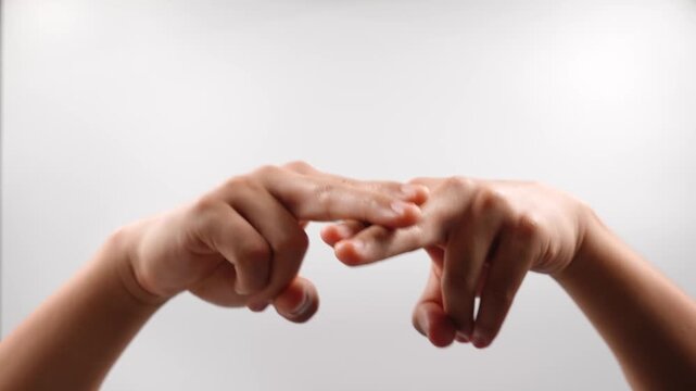 To sign "sit" in American Sign Language (ASL), you place the index and middle fingers of your dominant hand across the index and middle fingers of your non-dominant hand
