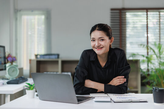 Confident asian businesswoman smiling while working in office