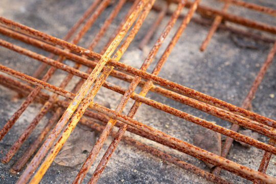 Rusty steel rebar mesh grid iron concrete construction metal structure lies outdoors, evoking gloomy mood of neglected strength and weathered durability at an industrial site
