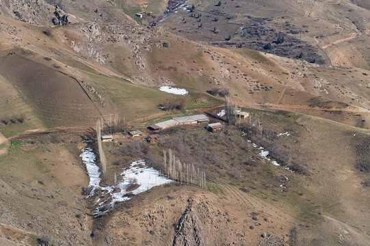 High angle view of Uzbek farm in Chatkal Mountain Range in late winter