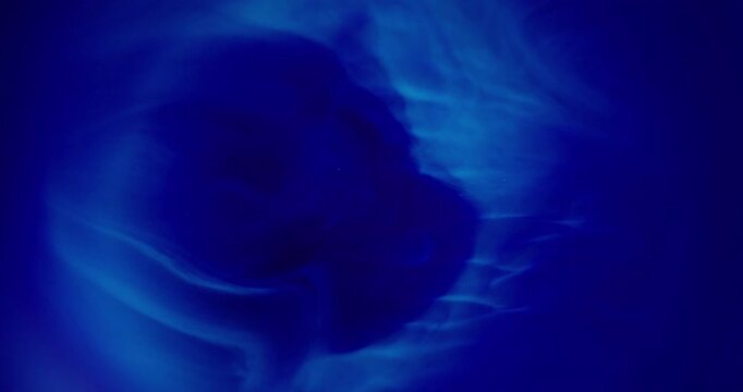 Blue shiny splash. Blur color pigment. Navy sparkling paint water texture bright liquid vibrant fluid spreading on abstract art background.