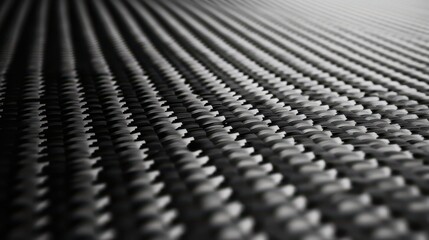 Fototapeta premium Close-up of Carbon Fiber Surface with Textured Pattern and Light Reflection