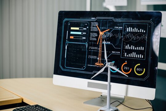 In a modish office, a wind turbine project unfolds on a computer monitor, setting a global standard for environmental governance. Teamwork and innovation are key in the meeting room.