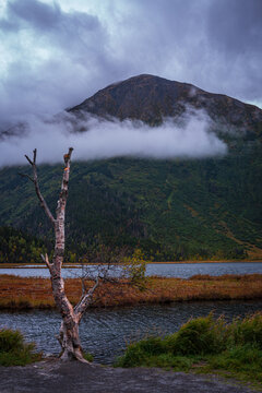 Alaska autumn landscape at Tern Lake with clouds over Wrong Mountain and Right Mountain in the town of Moose Pass at the crossroad of Seward and Sterling Highways