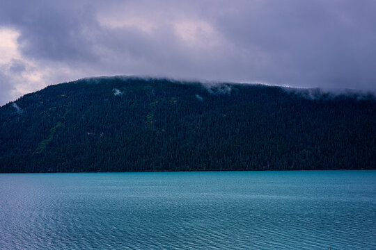 Alaska autumn landscape with clouds over the mountains above Kenai Lake along Seward Highway