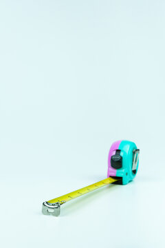 Vertical frame showing yellow roll tape measure extended to 8 inches (18 cm) on clean white background. Perfect for construction visuals, carpentry themes, engineering projects, and DIY measurement co