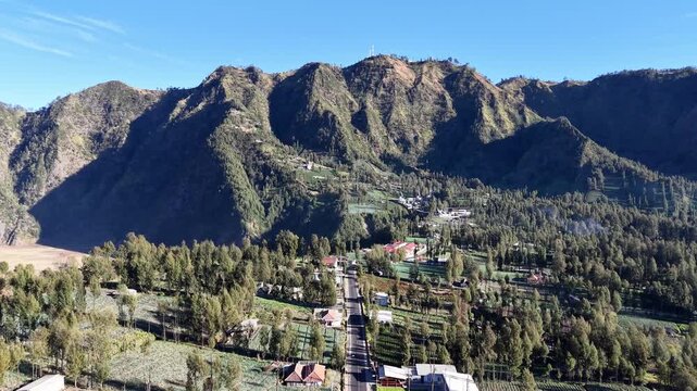 Aerial view of Cemoro Lawang village, terraced fields and dramatic mountain ridges