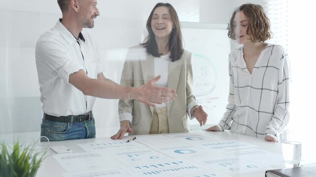 Business team collaborating and analyzing financial charts and graphs during a productive meeting in a modern office. Business people concept