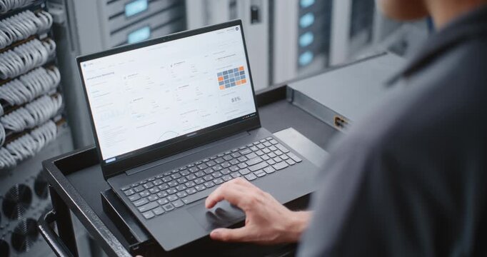 Male Data Center Engineer Investigates Cyber Attack Alert Through Linux CLI, Monitoring Server Status and Entering Emergency Commands During Active Security Response Across Enterprise Infrastructure.