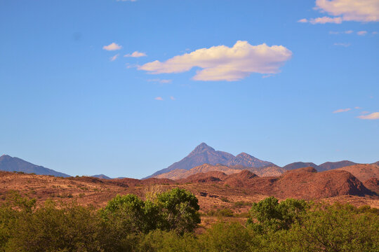Green Trees, Mountains and Blue Sky with Clouds