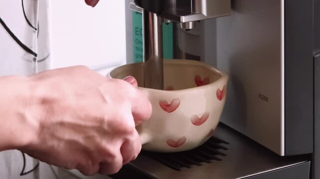 Drink preparing. Making coffee. Female hands using automatic espresso machine for fresh aroma morning beverage at home kitchen.