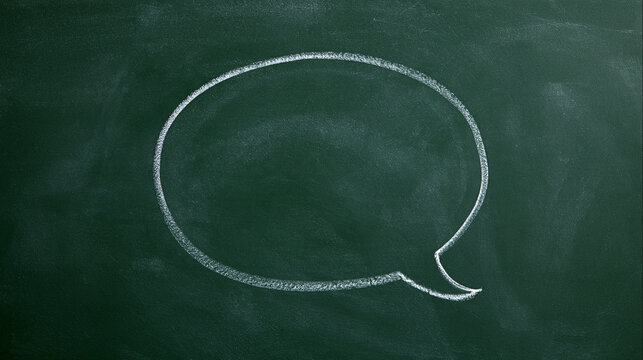 White chalk hand-drawn speech bubble on a dark green chalkboard background. Communication concept for education and design.