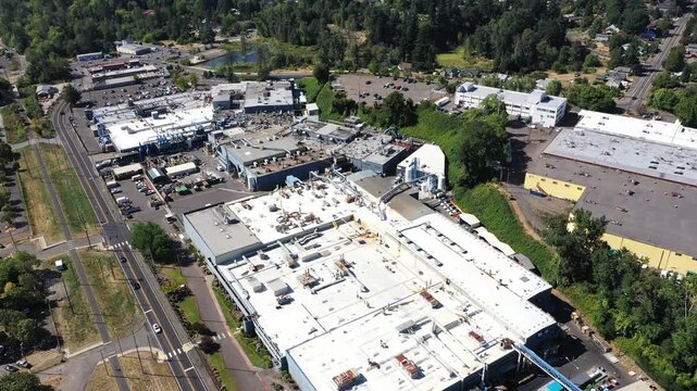 4K aerial drone footage of large aerospace metal manufacturing and casting factory in Portland, Oregon, USA, showing production buildings, machinery, pipes and industrial infrastructure