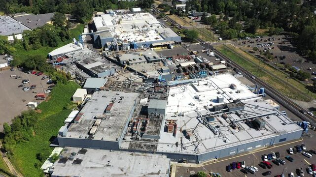 4K aerial drone footage of large aerospace metal manufacturing and casting factory in Portland, Oregon, USA, showing production buildings, machinery, pipes and industrial infrastructure