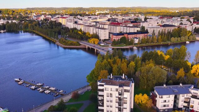 Aerial drone city dolly zoom in Finland, H&auml;meenlinna during evening over lake and bridge