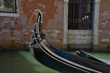 Traditional gondola in a canal, Venice © Robin